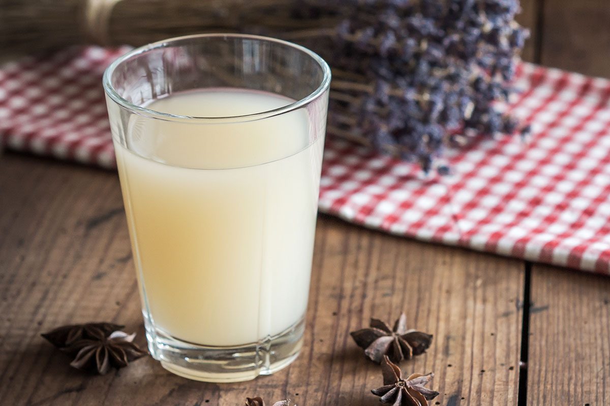 Glass of French Pastis on a wooden table