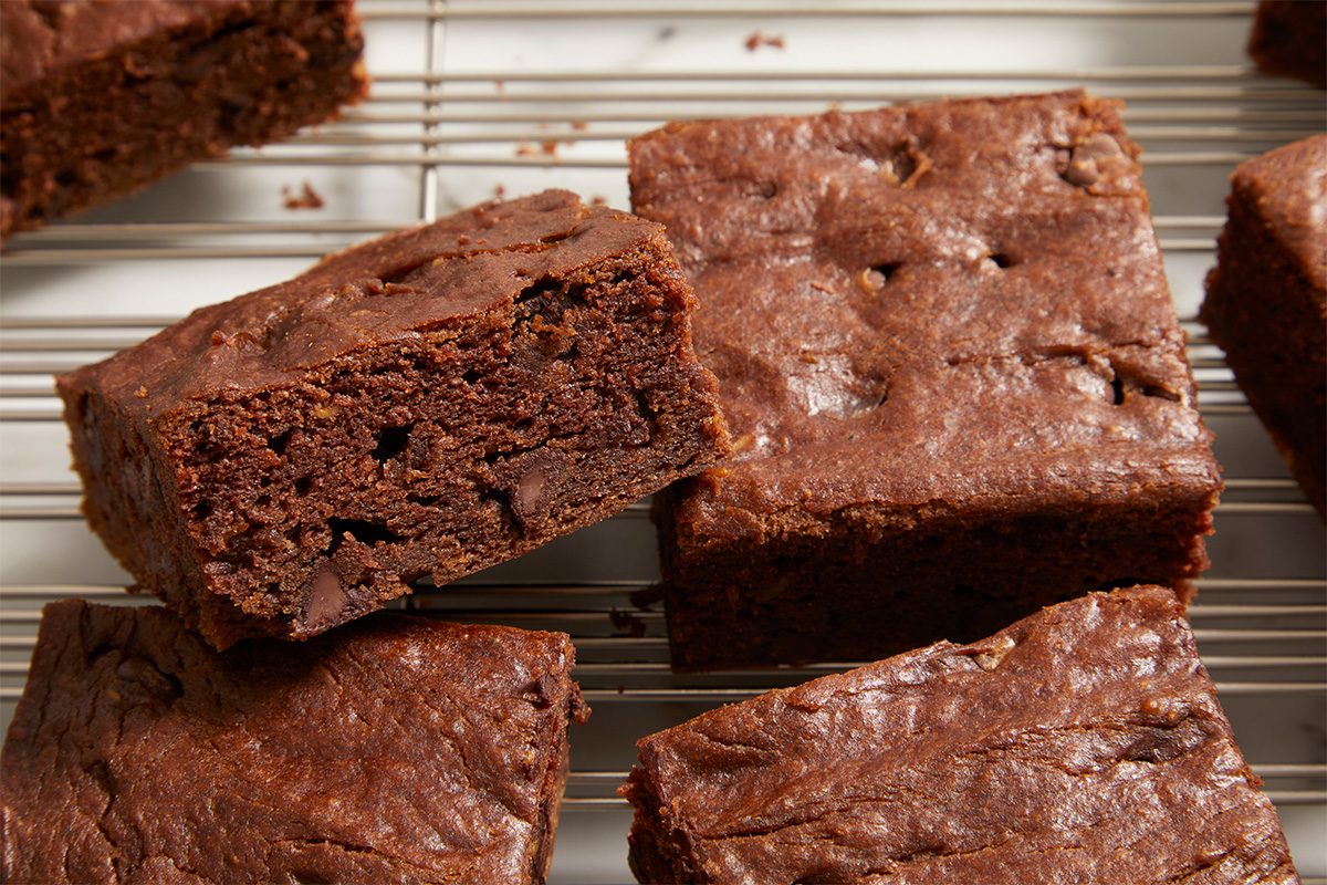 Overhead horizontal close-up of avocado brownies showing moist texture and chocolate chips.
