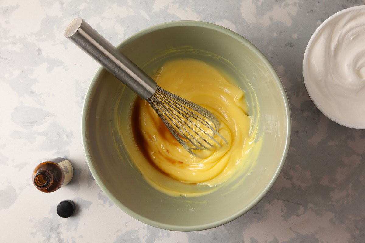 pudding mix and milk being mixed in a bowl