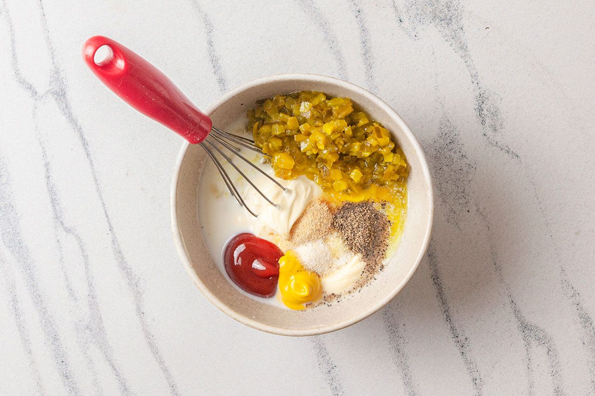 Mayonnaise, pickle relish, ketchup, mustard, and seasonings are whisked together to make a creamy secret sauce.