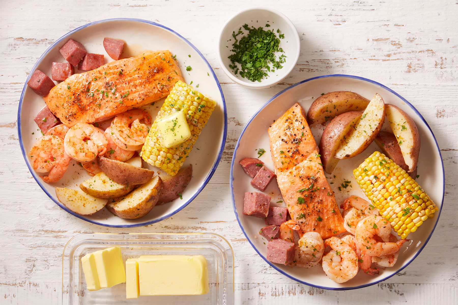 2 plates of Cajun Boil On The Grill on a counter