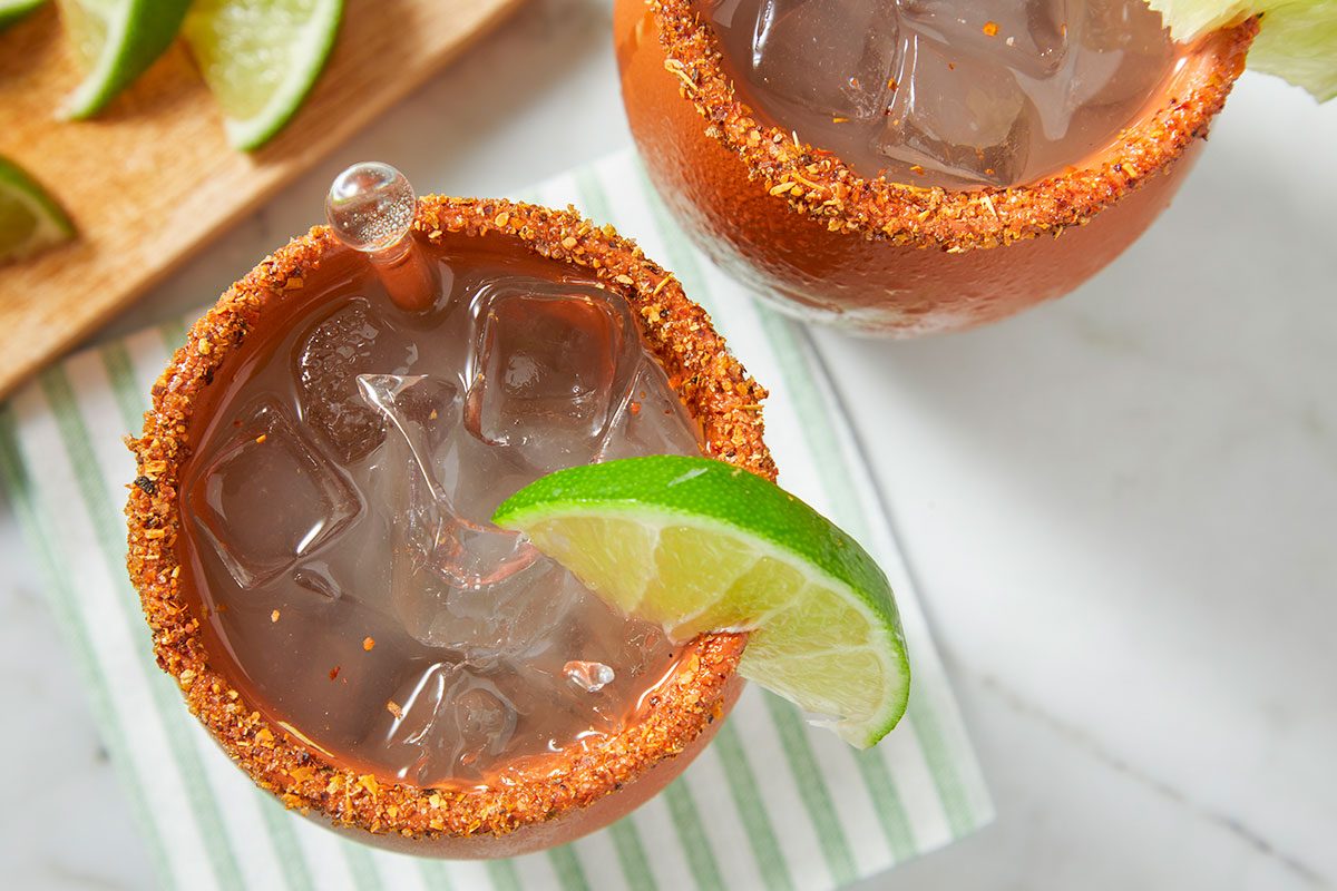 Overhead view of the finished cantarito highlights ice, citrus garnish, and Tajín-coated rim detail.