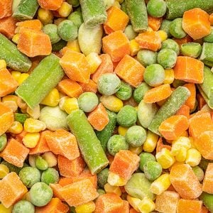 closeup background and texture of frozen vegetable medley - carrots, peas, green beans, corn, and baby lima beans