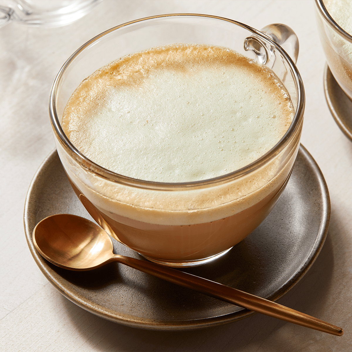 Starbucks Pistachio Latte in a glass cup with spoon
