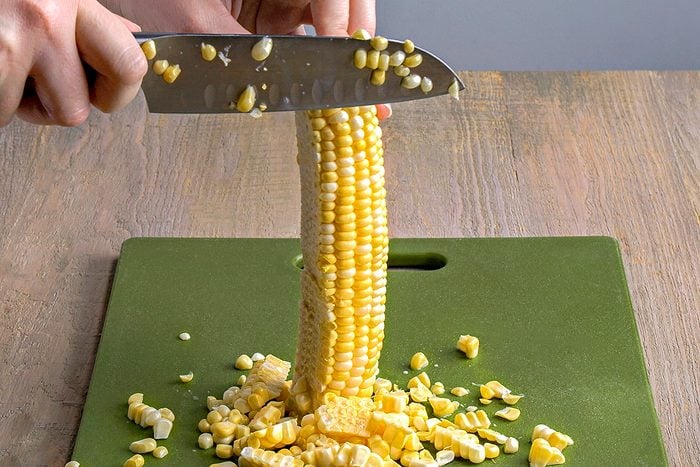 corn kernels being cut off cobs