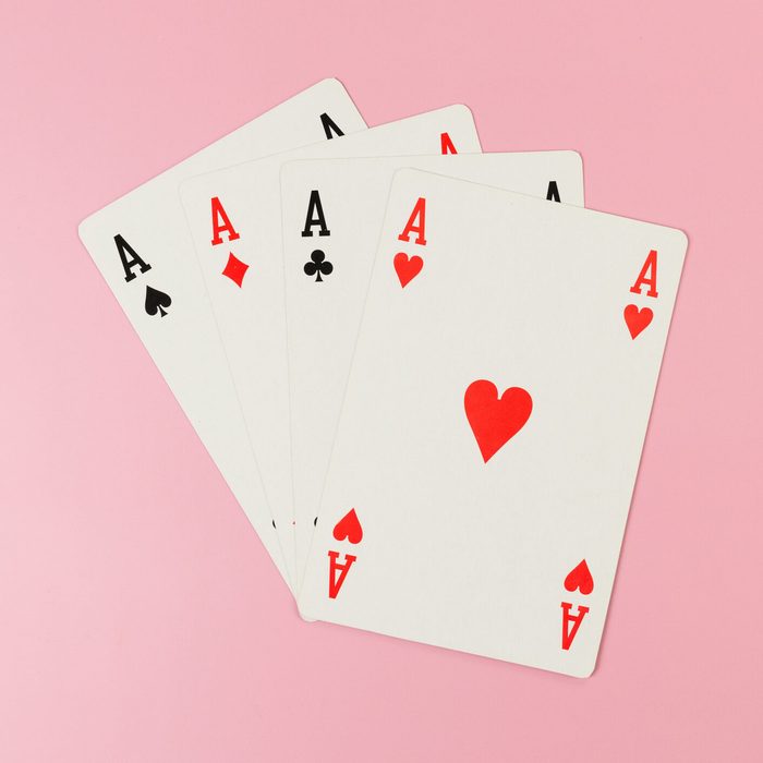 Top view of playing cards on pink background. Four aces cards, board game, poker.