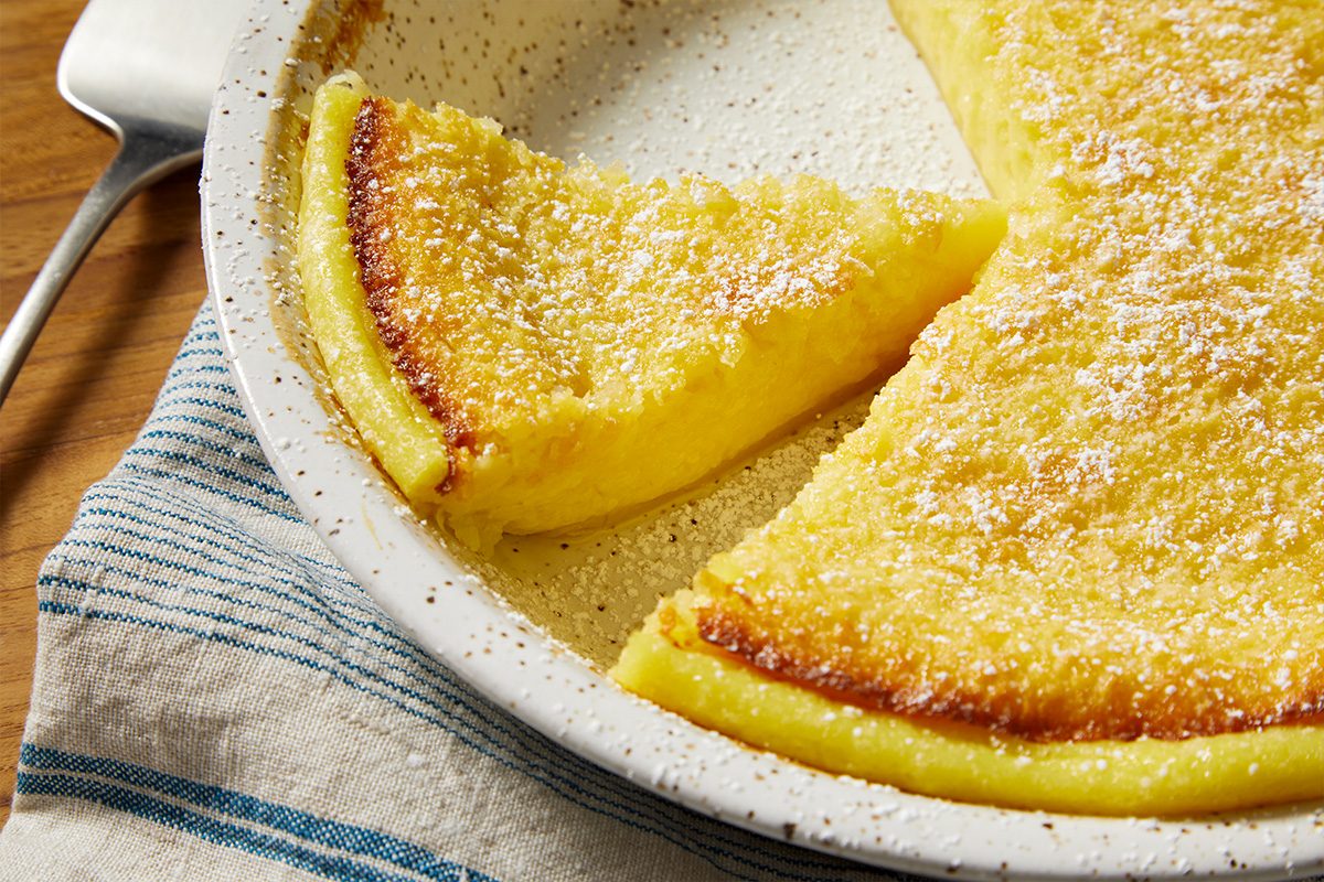 Overhead horizontal close-up of a slice of Impossible Pie showing creamy coconut texture and golden edges.