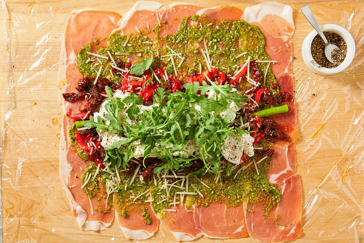 Fresh arugula is added and the filling is seasoned with cracked black pepper.