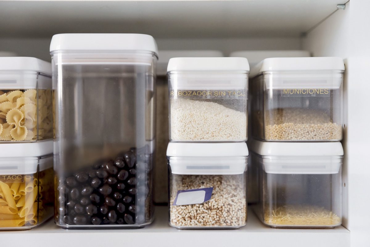 food items in storage containers on a kitchen shelf