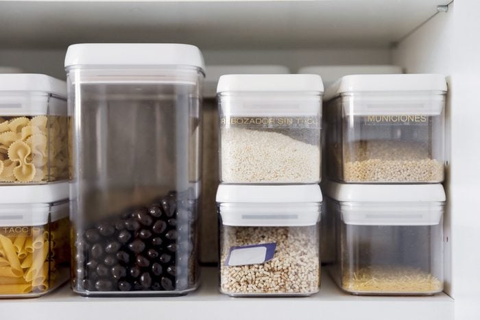 food items in storage containers on a kitchen shelf