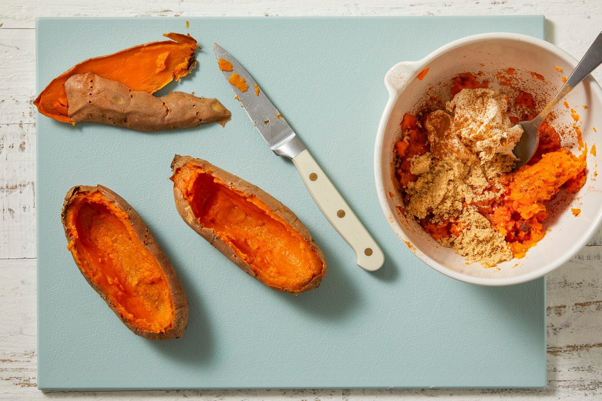 1/4-inch-thick sweet potato shells on a chopping board with their pulp scooped out