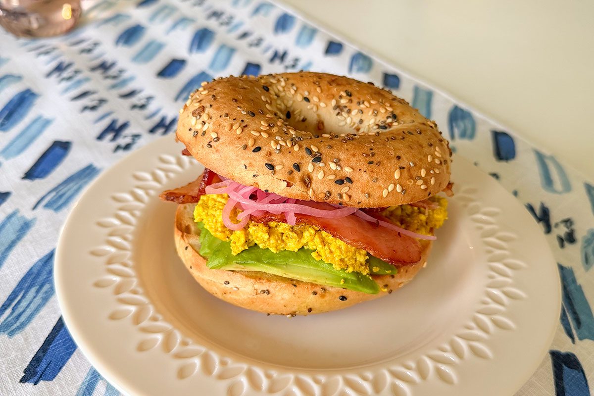 A burger of scrambled eggs and bacon served on a plate, Ready to eat