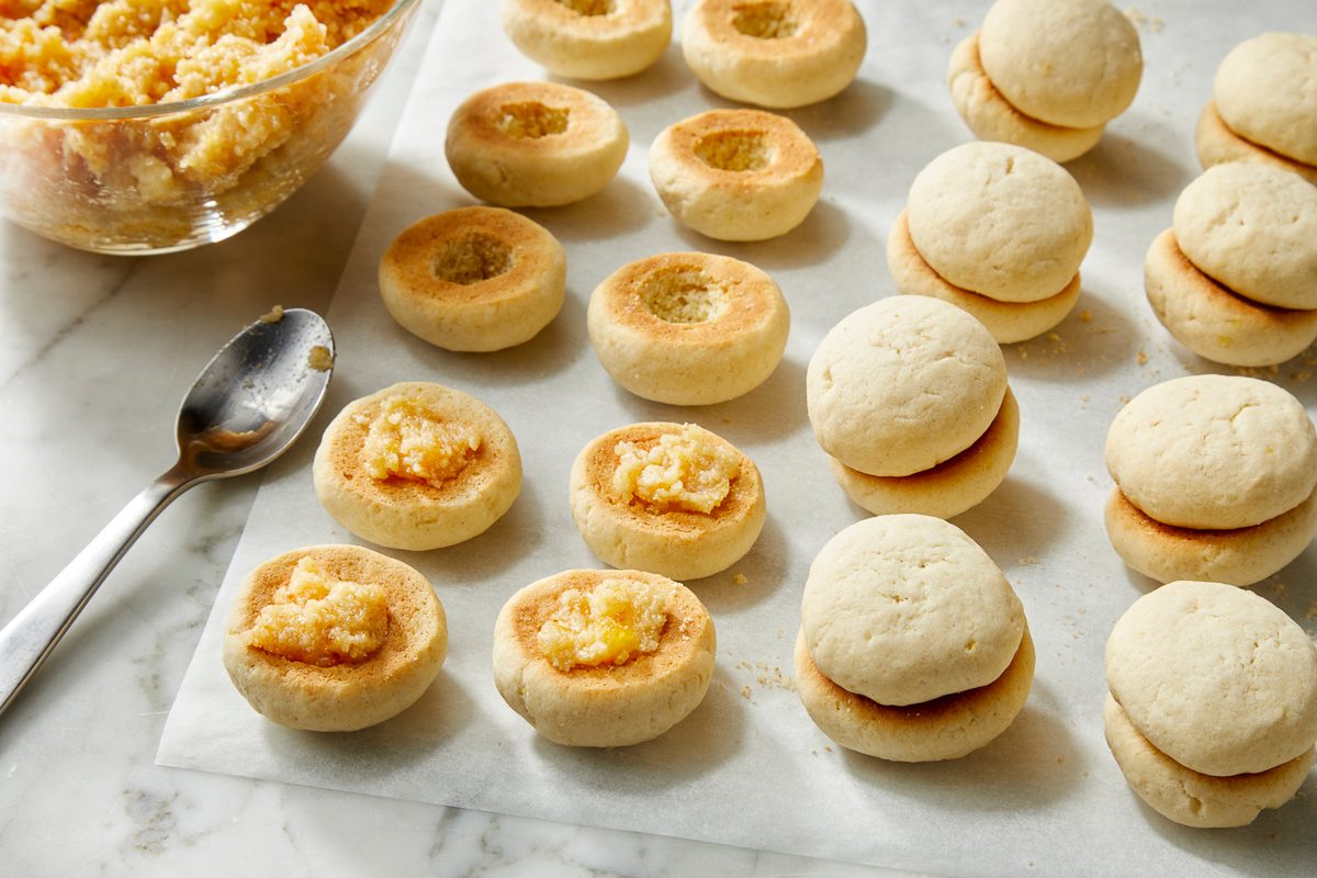 Overhead view of assembled peach cookies sandwiched together, forming peach-shaped cookies before decoration.