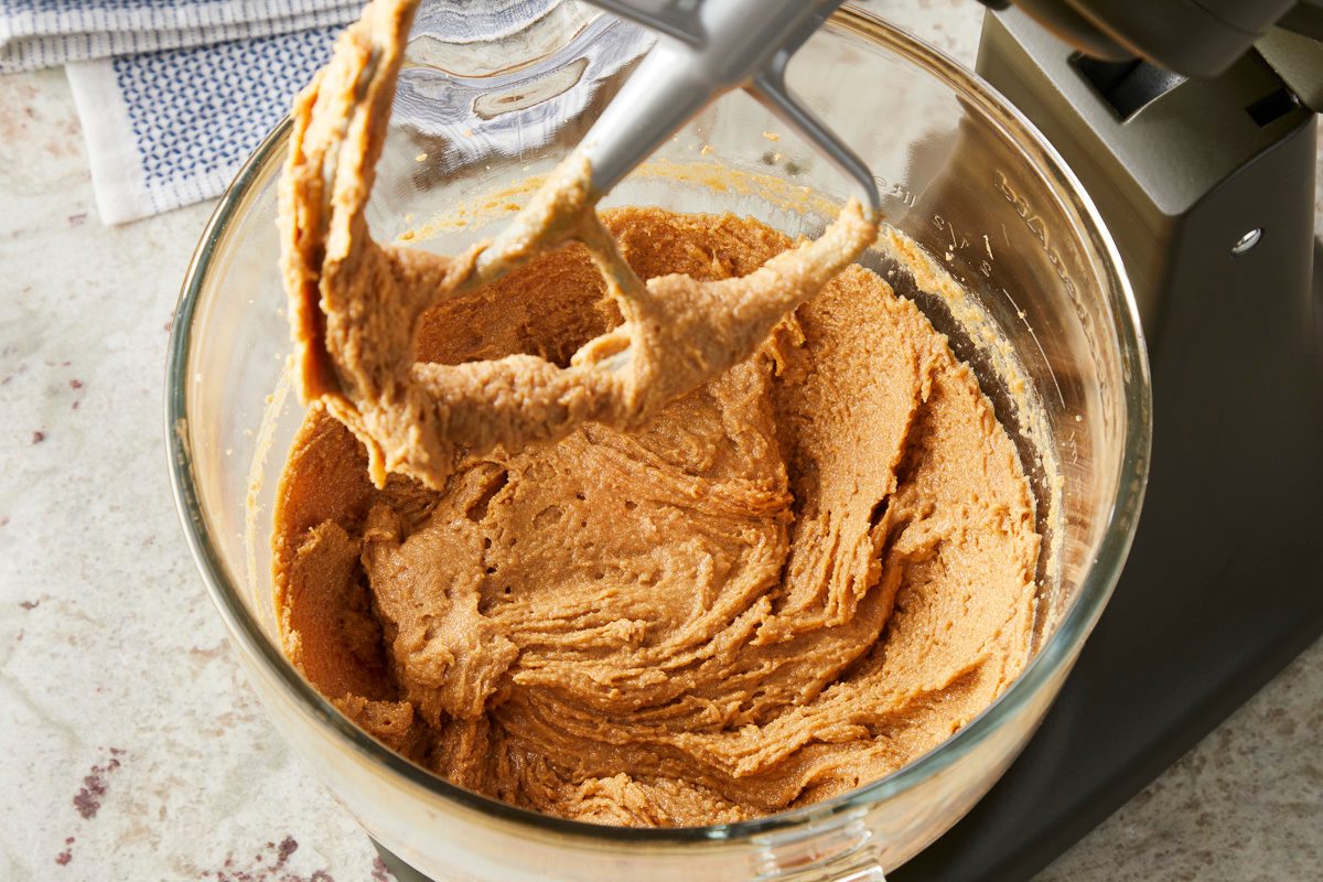 Peanut Butter, sugar and brown sugar being creamed together in a bowl