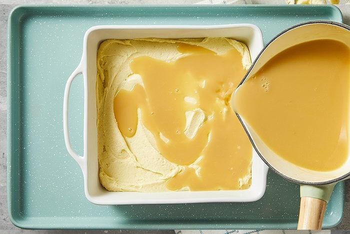 A horizontal overhead image shows maple cream sauce being poured over batter in a baking dish.
