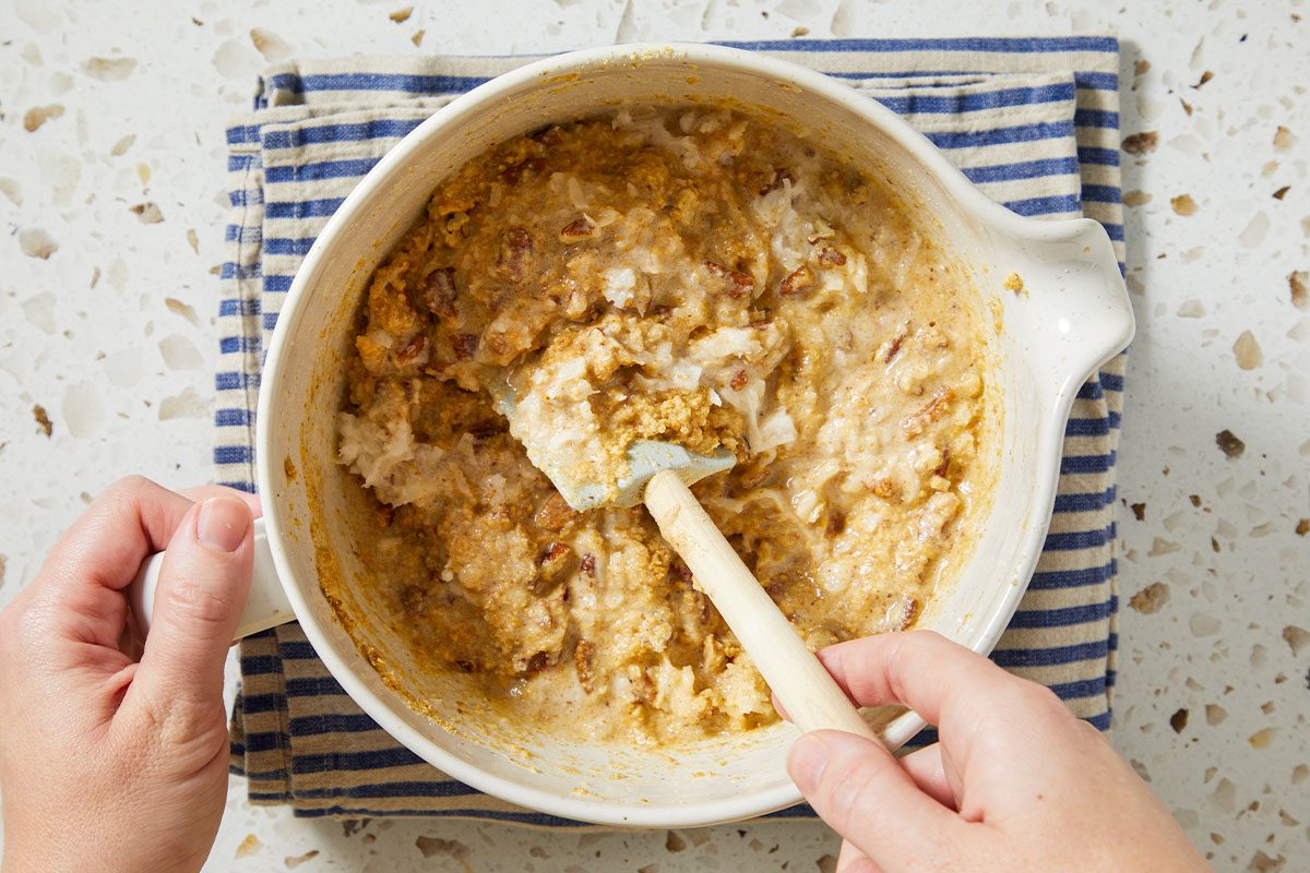 A horizontal overhead image shows a thick pie filling mixture being stirred in a bowl, with visible coconut, pecans, and graham cracker crumbs.