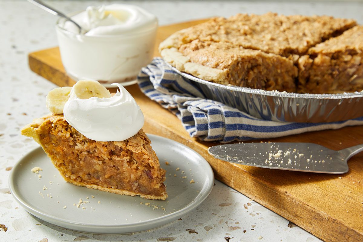 A horizontal image shows a plated slice of sawdust pie topped with whipped cream and served alongside the remaining pie.