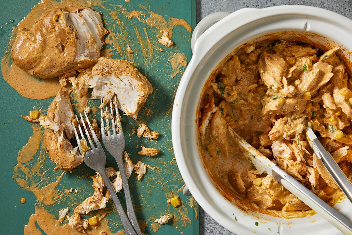 Overhead horizontal step-by-step image showing shredded chicken being pulled apart and mixed into creamy street corn sauce.