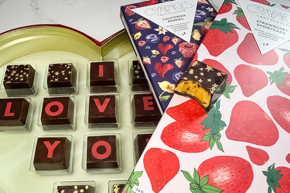 chocolate bars on top of opened heart shaped box of chocolates