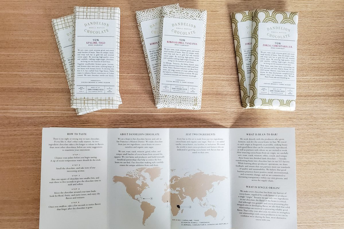 top view of chocolate bars and brochure on wooden surface