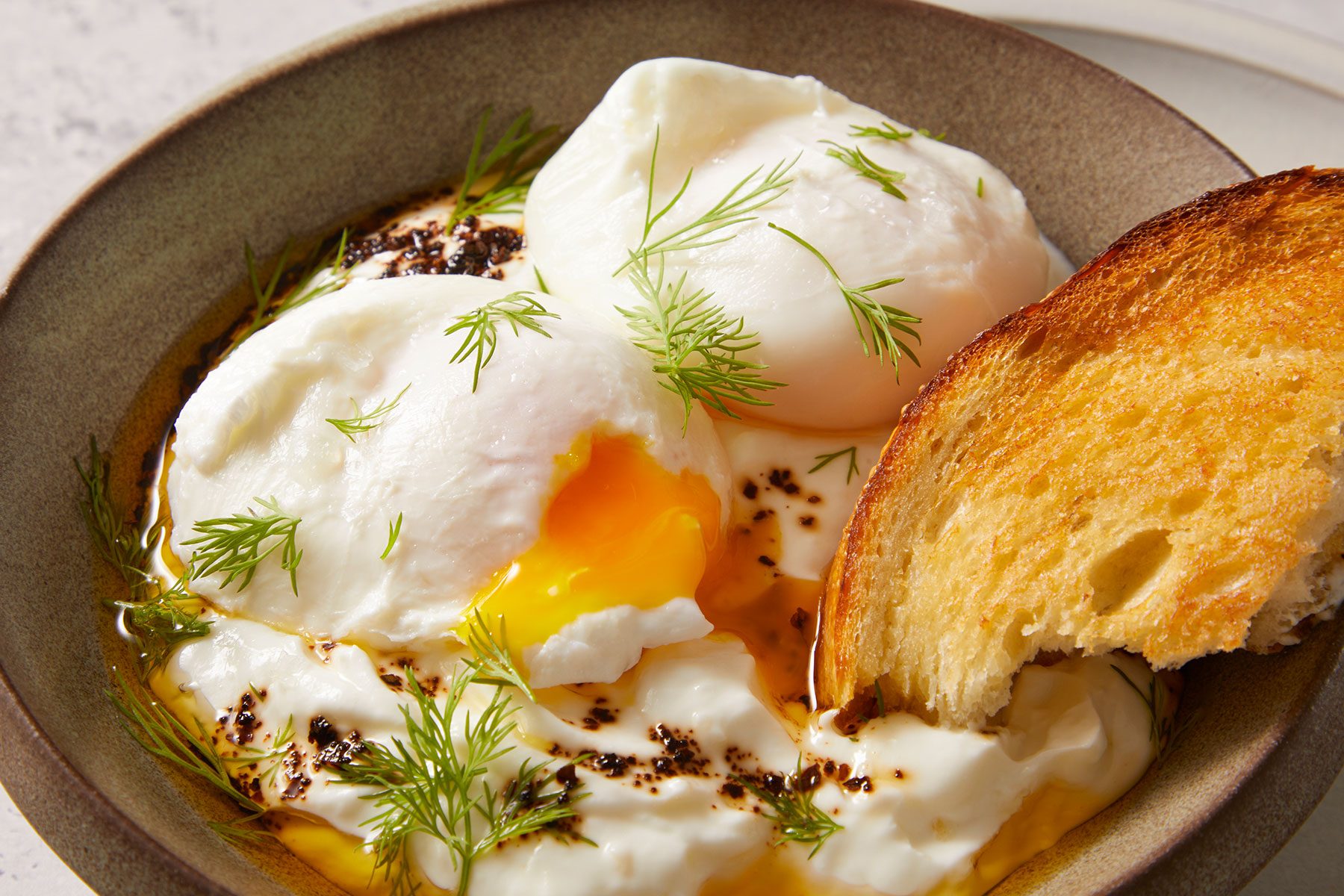 Turkish Eggs Cilbir served with toast