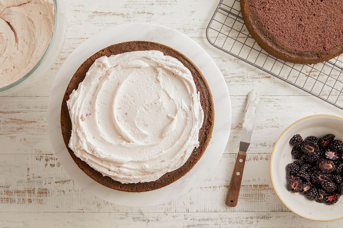 A horizontal image shows frosting being spread onto a cake layer before assembly.