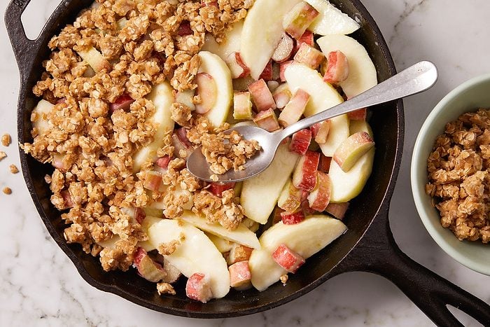 A coarse crumbled mixture of oats, brown sugar, butter, flour and cinnamon sprinkled over chopped fruits.