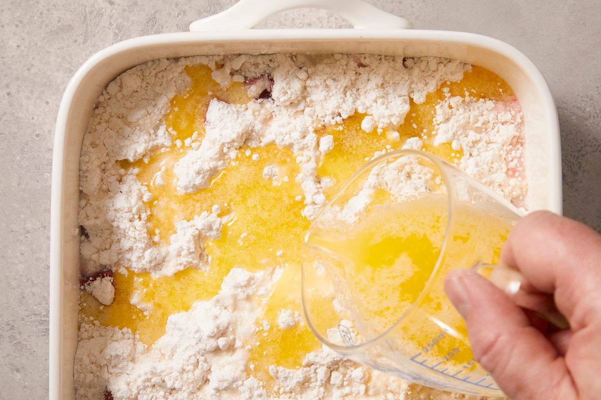 A horizontal overhead image shows melted butter being poured evenly over the cake mix topping in a baking dish.