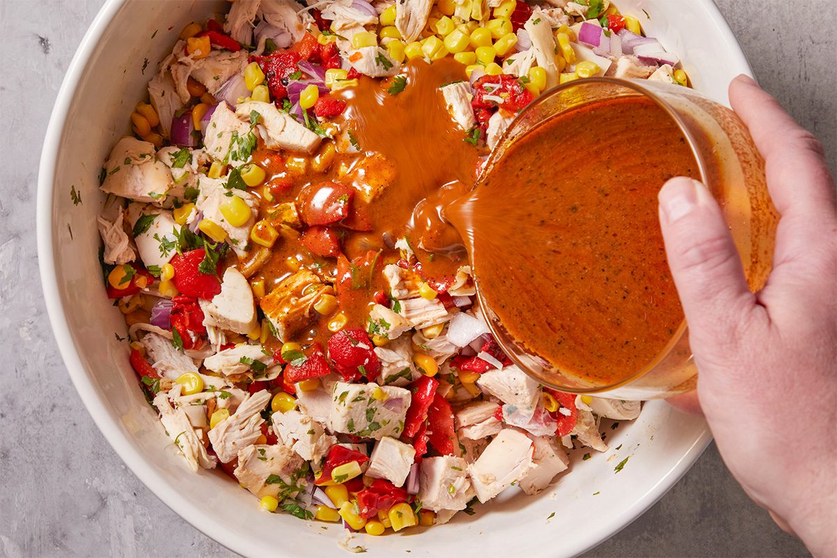 Pour the dressing over the chicken mixture to evenly coat all ingredients.