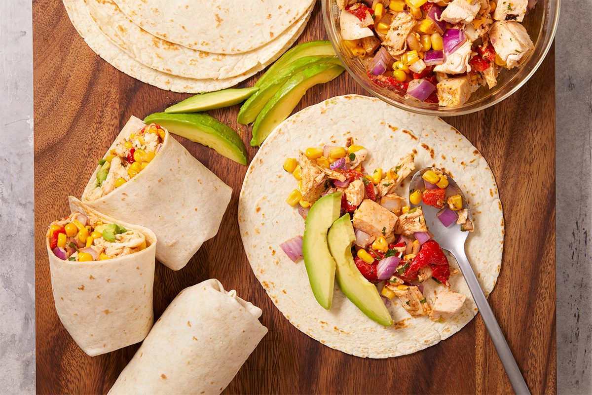Wrap the chicken salad in a flour tortilla with avocado slices to create a fresh and portable wrap.