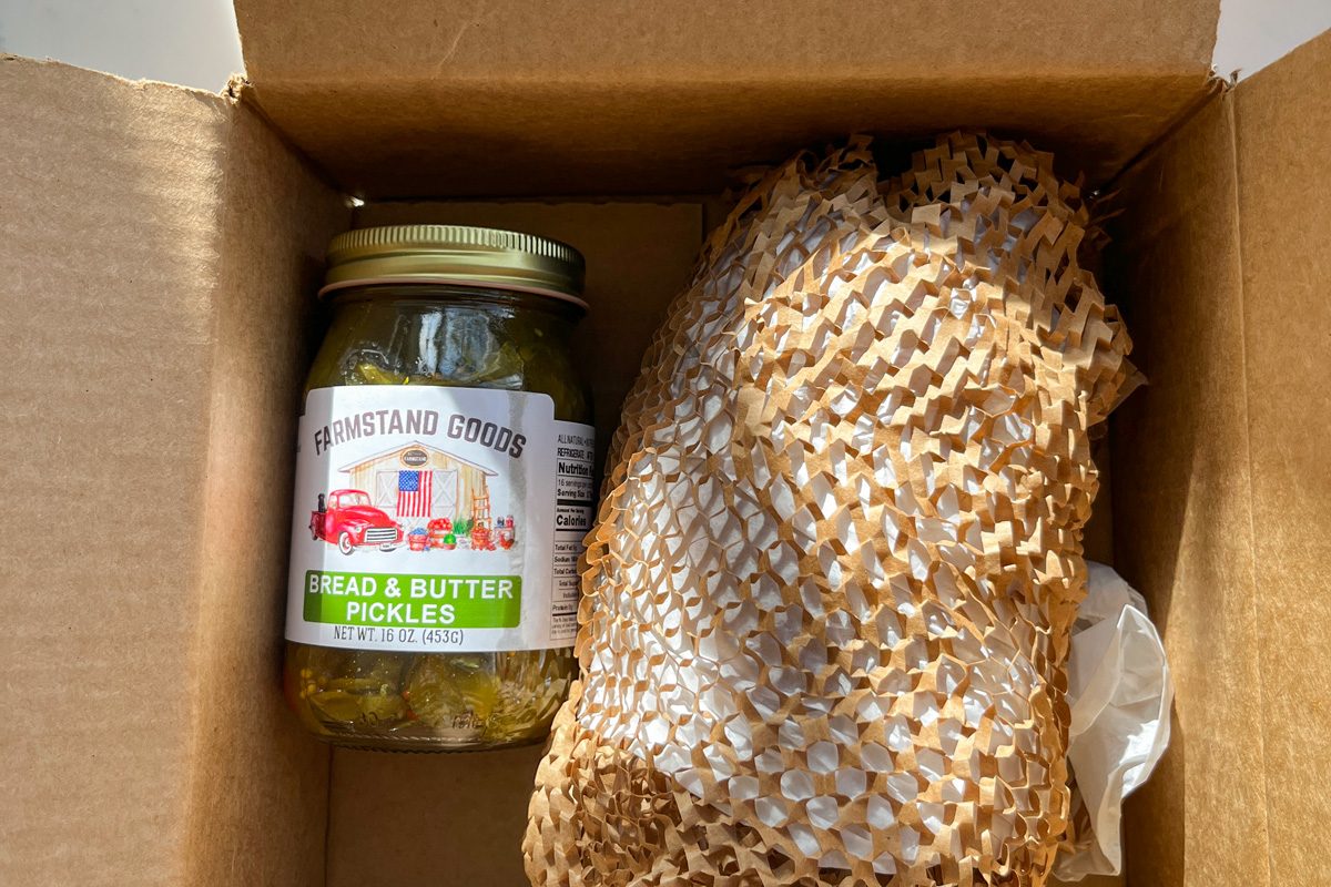 top view of a jar of pickle in cardboard packaging box
