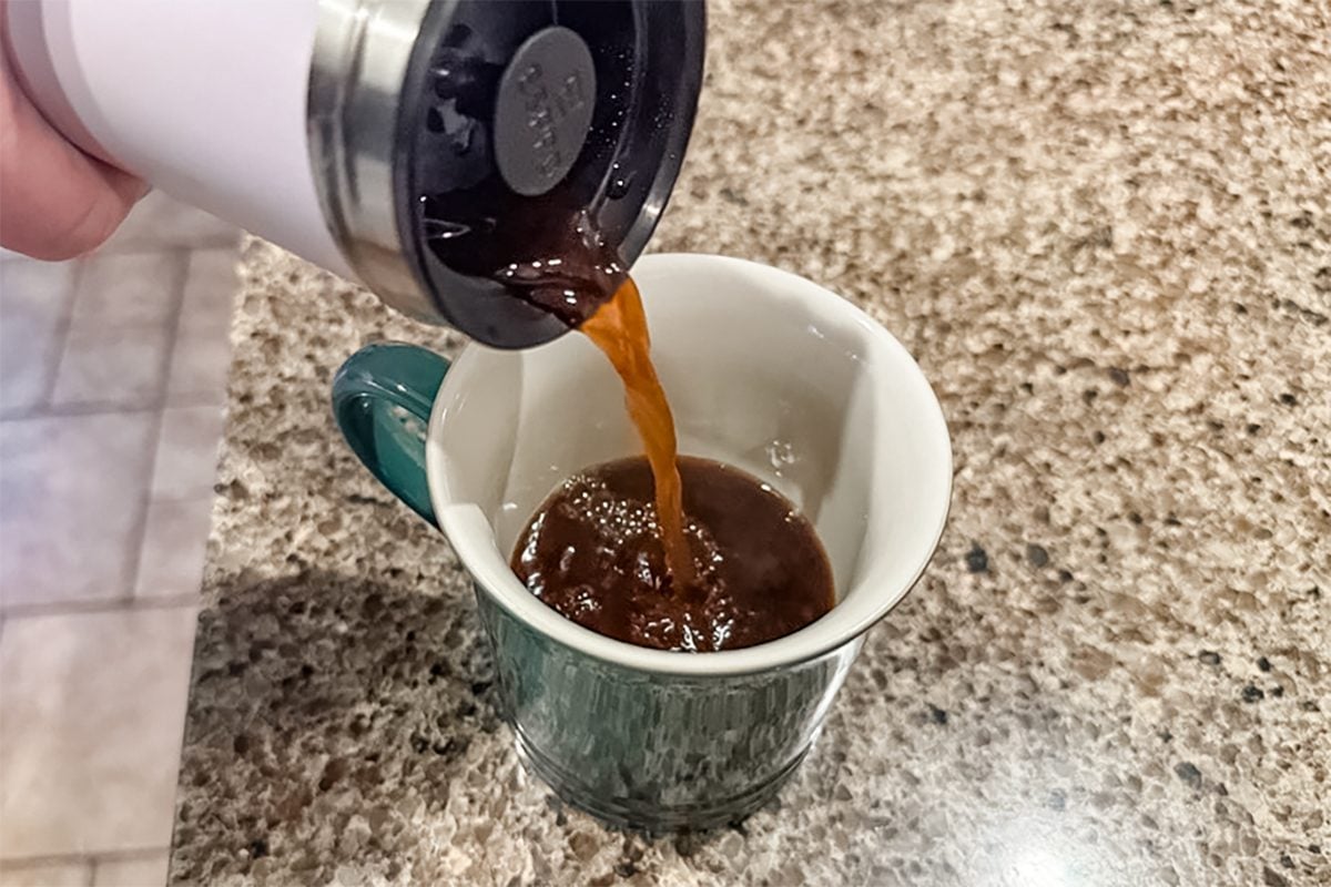 coffee being poured into a mug from Espro Travel French Press