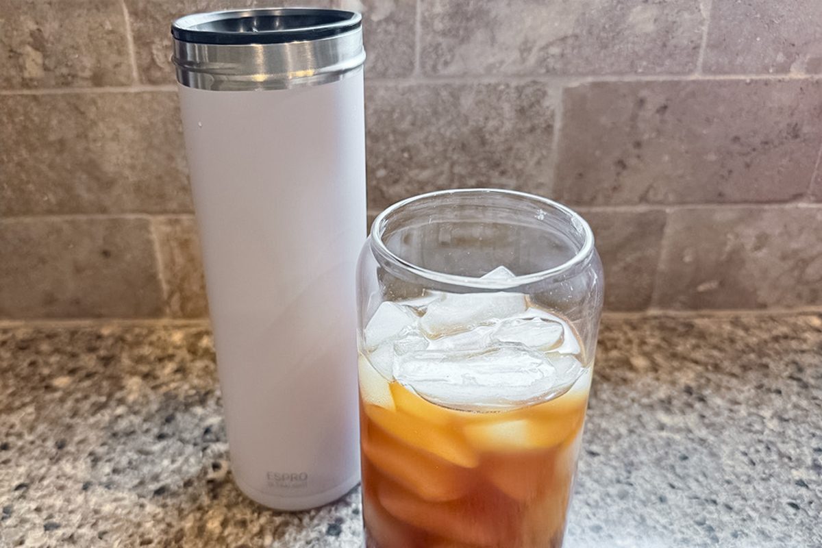 coffee with ice cubes in a clear glass in front of Espro Travel French Press