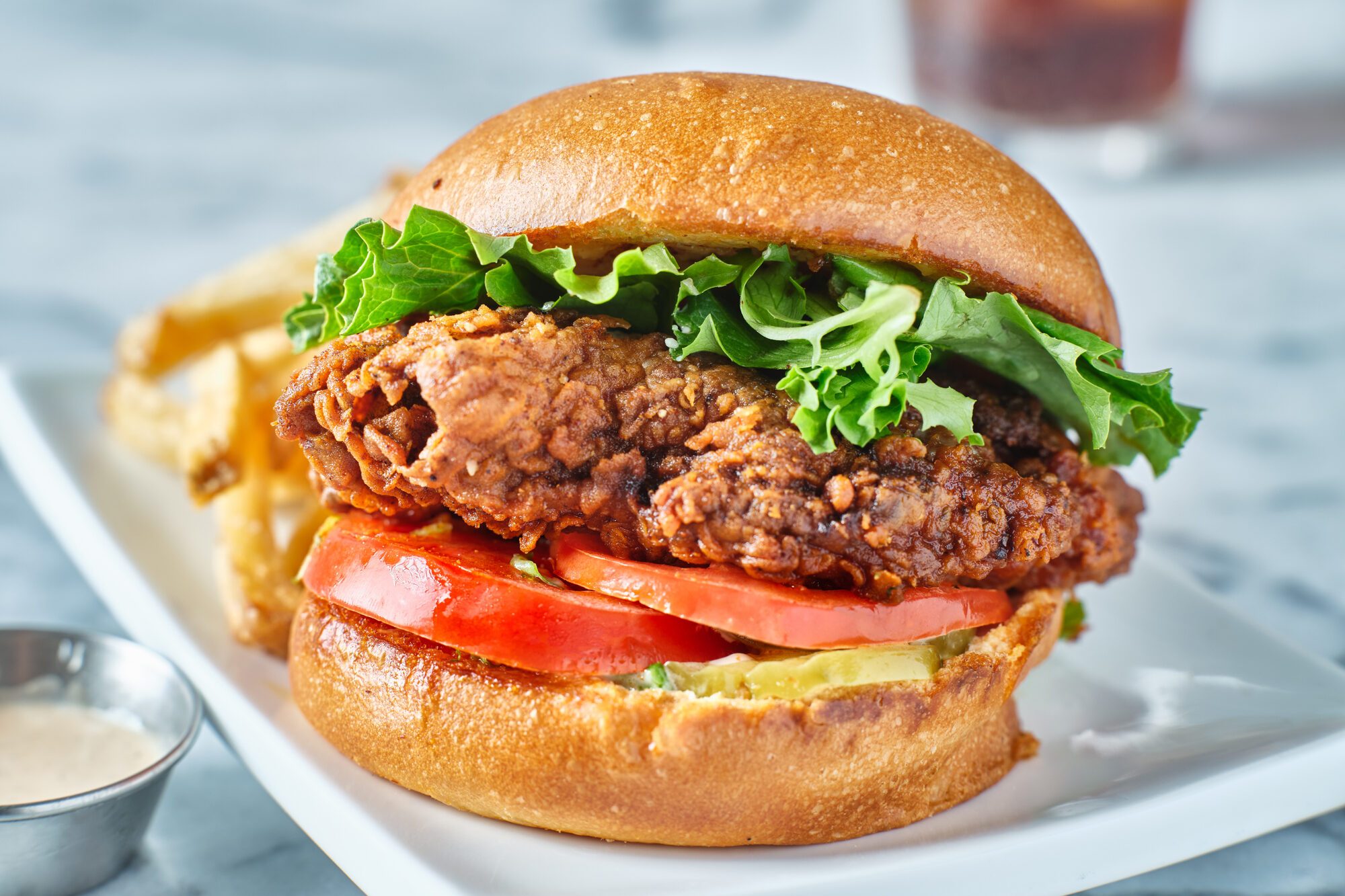 crispy fried chicken sandwich on brioche bun with french fries