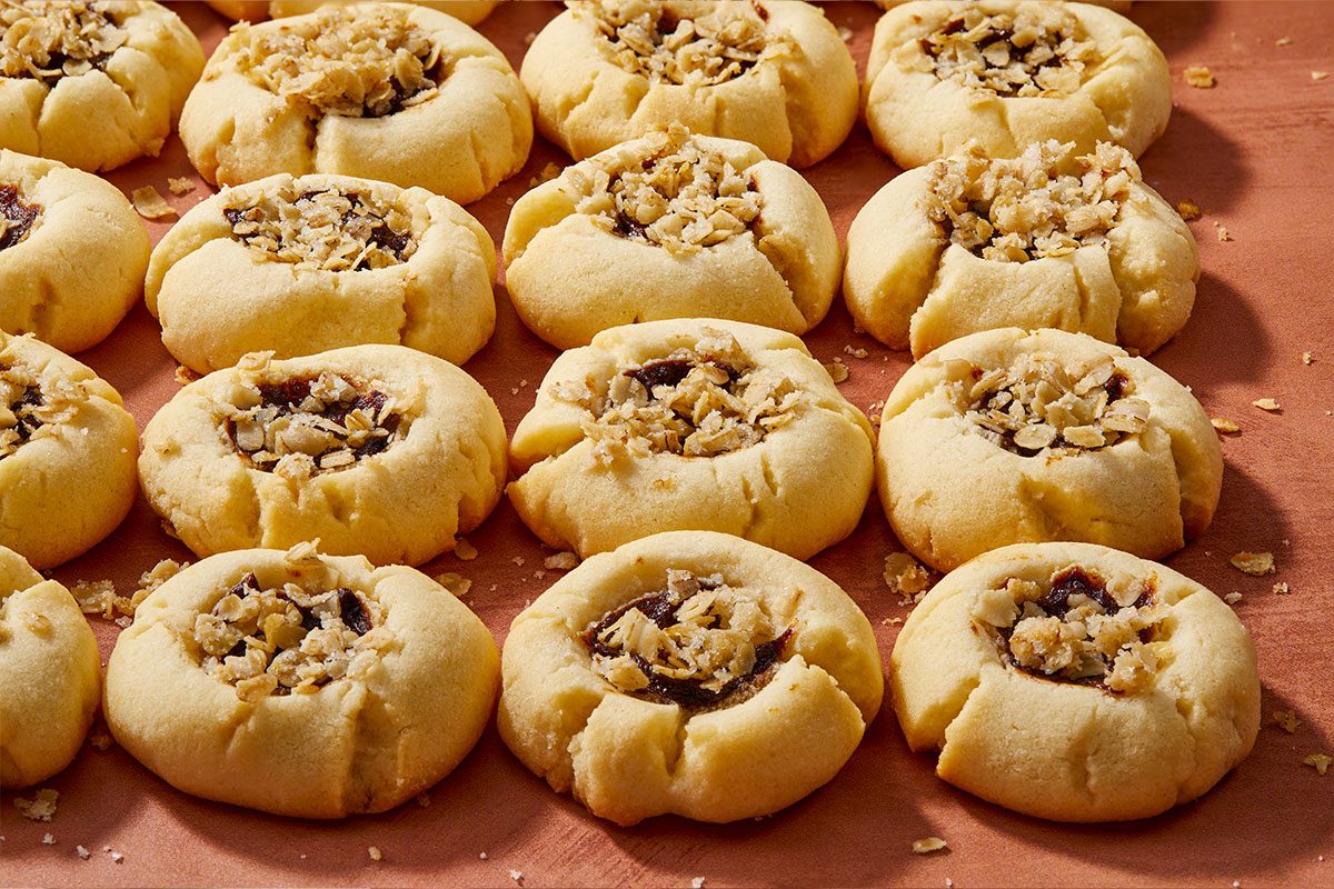 Eye Level horizontal image of thumbprint cookies. The baked cookies are filled with jam and topped with chopped nuts. | [Original] RMS 281597; Sugar Plum Thumbprint Cookies; Horizontal AP; Pull