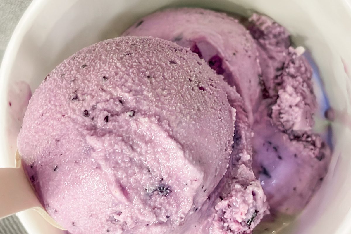 close up of purple ice cream in a white cup