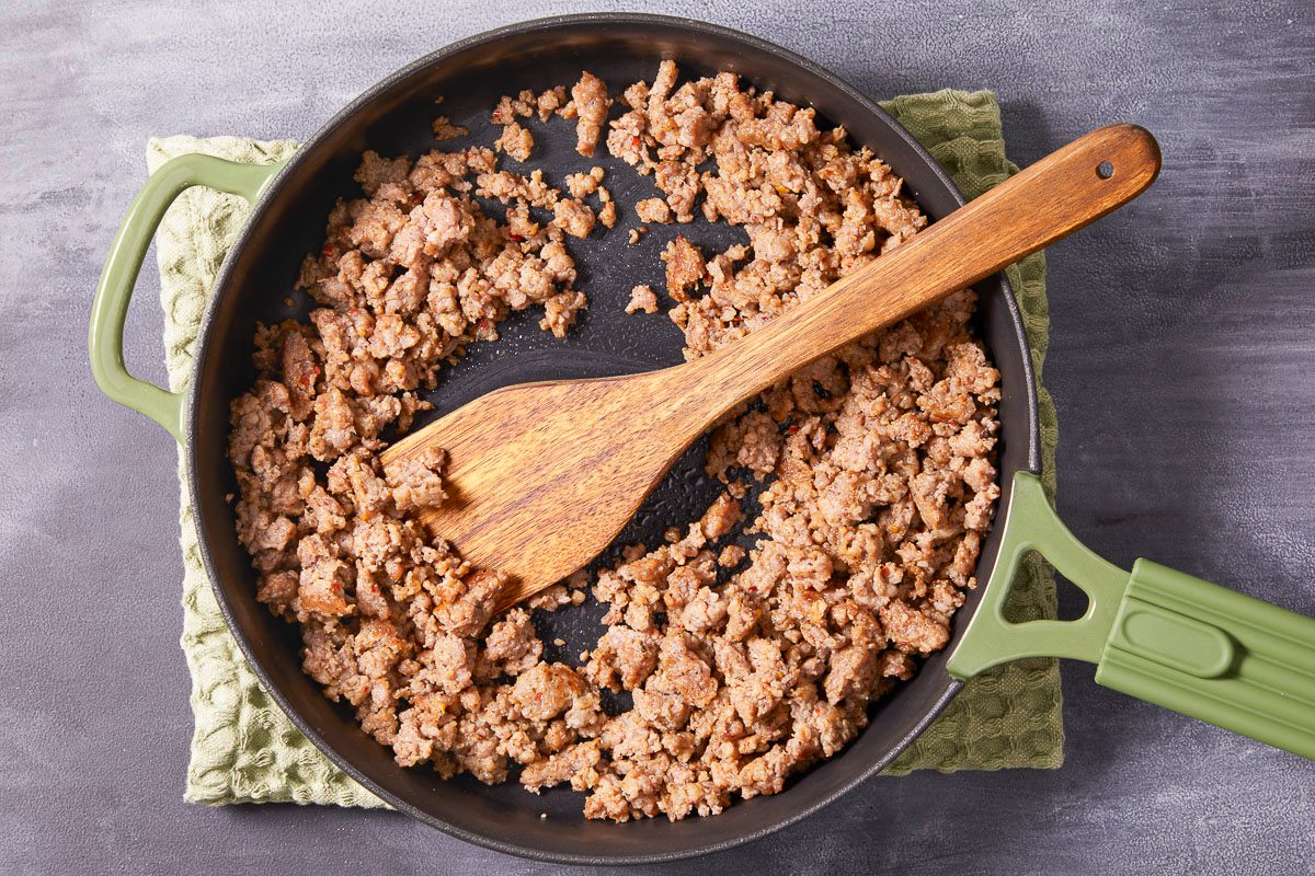 overhead image of cooked sausage in a large skillet