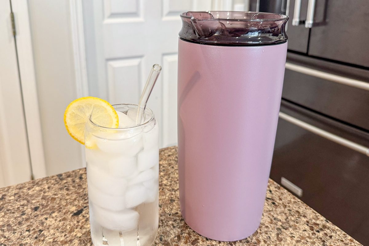 Brumate Togosa next to a drink with ice and lemon slice