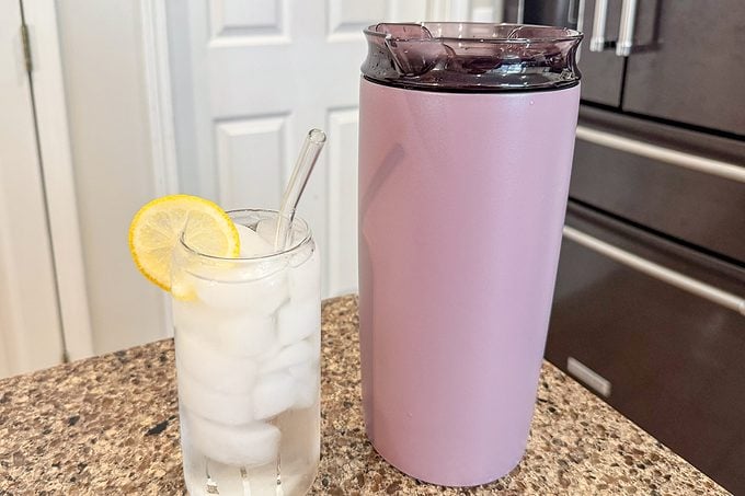 Brumate Togosa next to a drink with ice and lemon slice