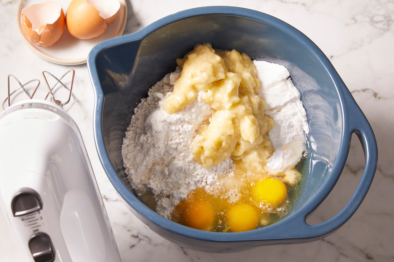 yellow cake mix, instant banana cream pudding mix, bananas, eggs, water and canola oil in a large bowl