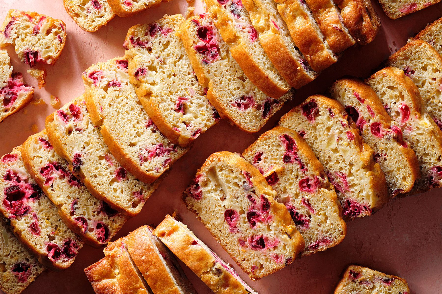 Cranberry Orange Bread pieces laid in lines on a kitchen counter.
