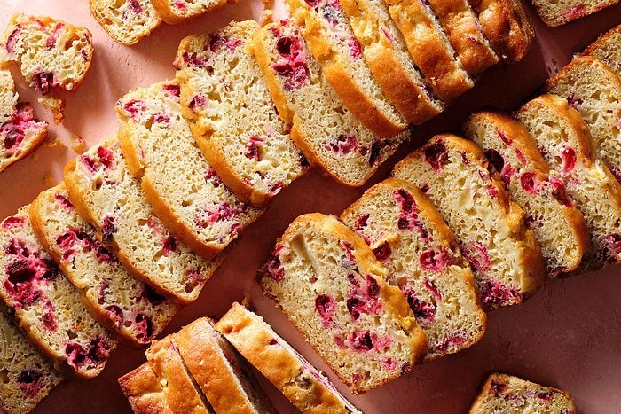 Cranberry Orange Bread pieces laid in lines on a kitchen counter.