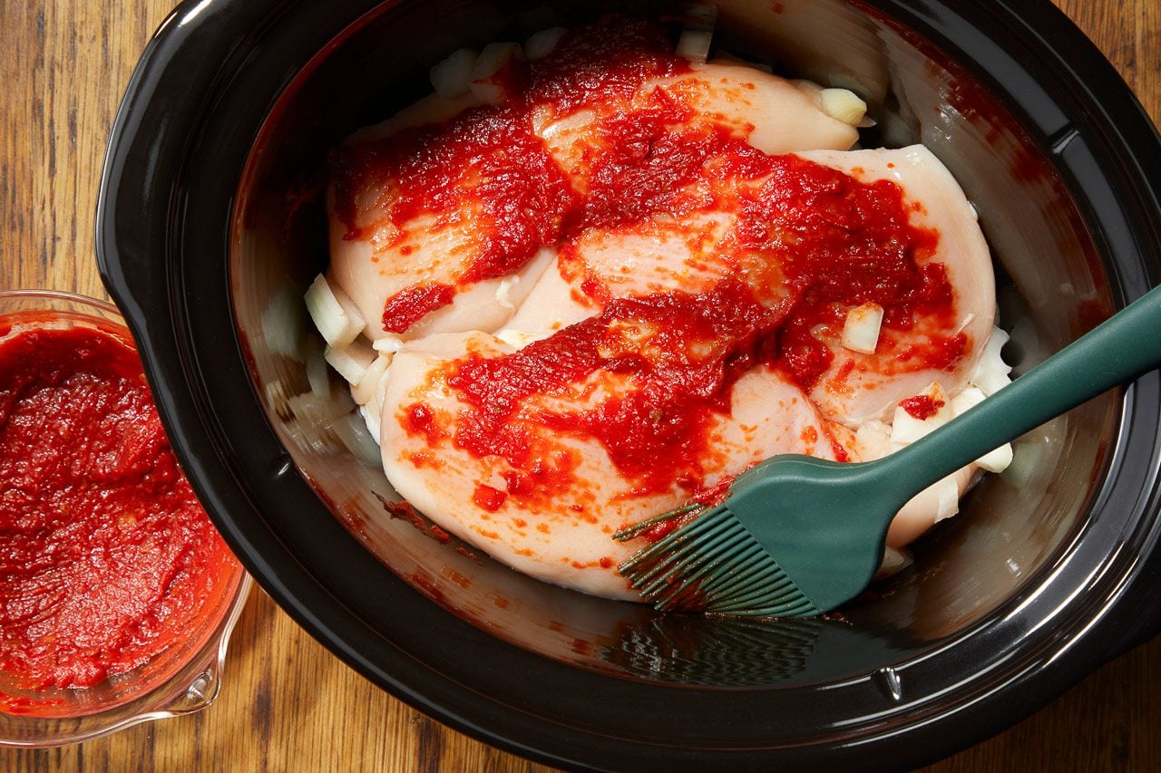 harissa, tomato paste and salt spread over chicken breasts