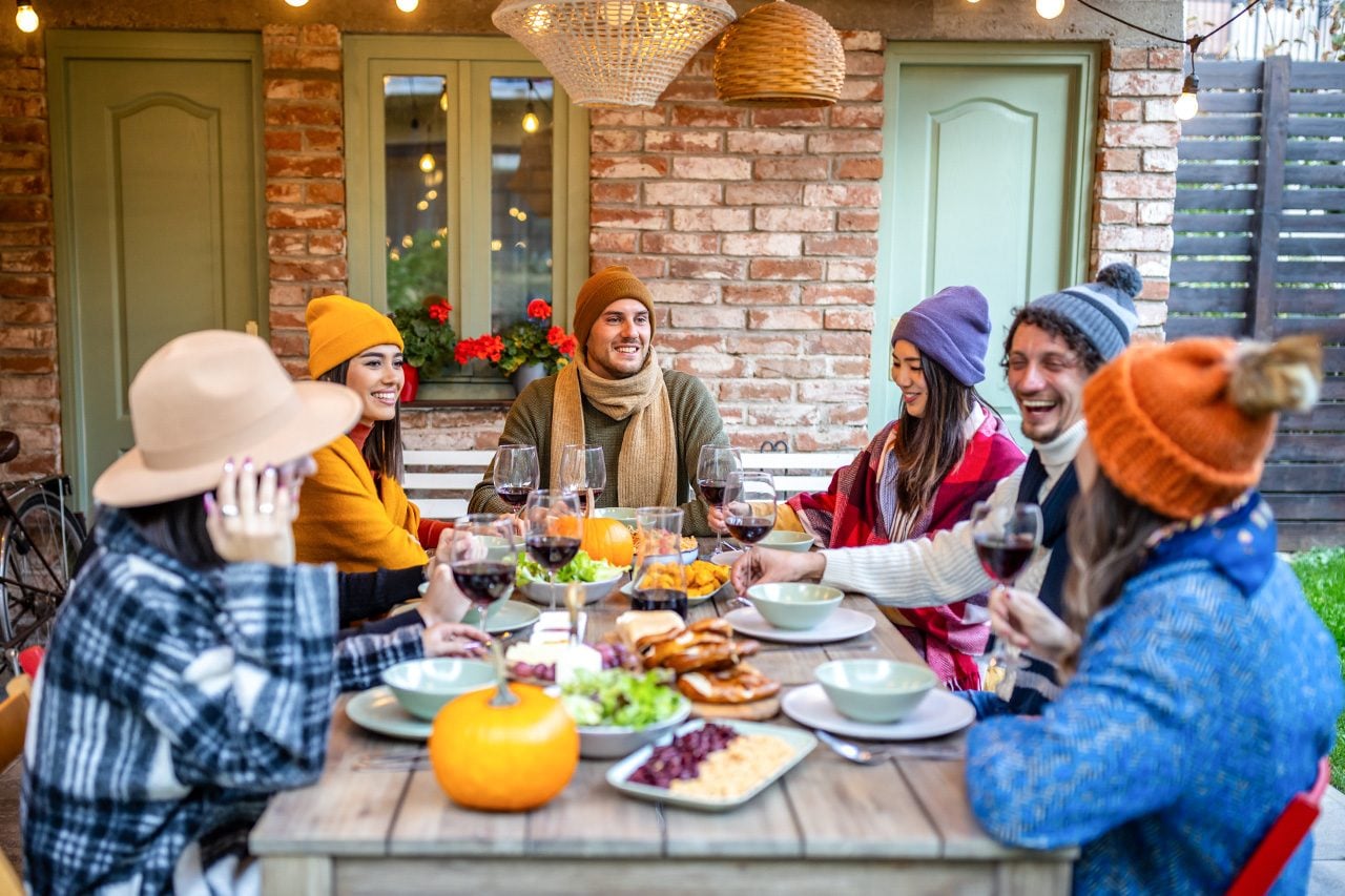 Group of friends having a meal at a garden party.