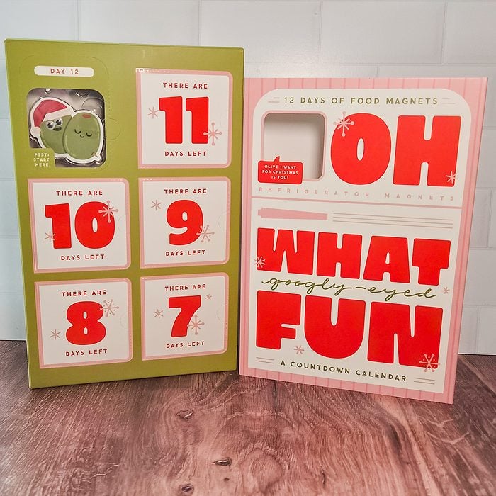 An open “Oh What Fun” countdown calendar shows Day 10 with a pea magnet revealed. The left side lists days 7 to 11, counting down to the holiday. The right side displays the main calendar cover in red and white.