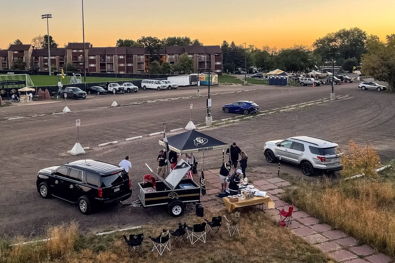Tailgating Colorado Buffaloes fans set up tents and prepare food before dawn before a noon Eastern time game between the Colorado Buffaloes and the USC Trojans at Folsom Field