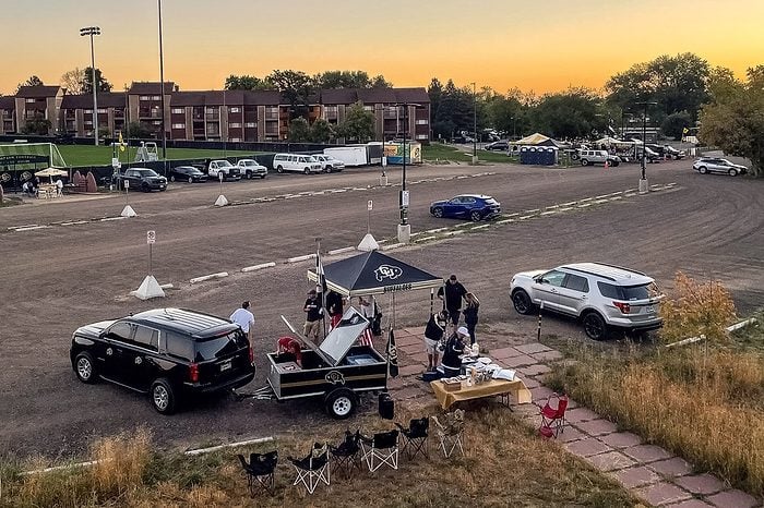 Tailgating Colorado Buffaloes fans set up tents and prepare food before dawn before a noon Eastern time game between the Colorado Buffaloes and the USC Trojans at Folsom Field